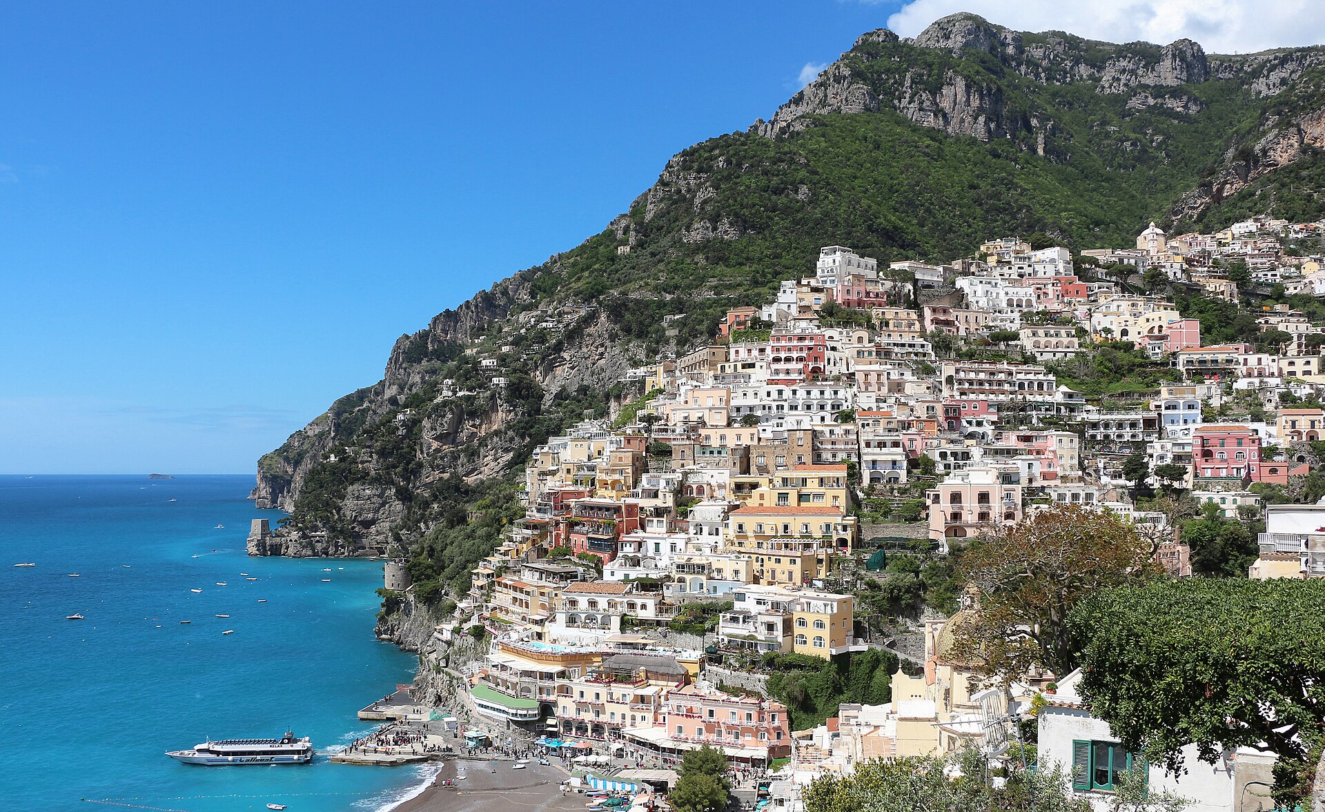 Positano's pastel houses stacked down the cliff to the sea, Amalfi Coast